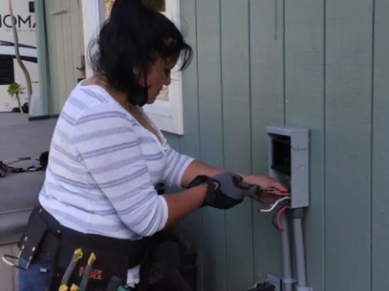 Licensed electrician wiring an exterior subpanel in Early